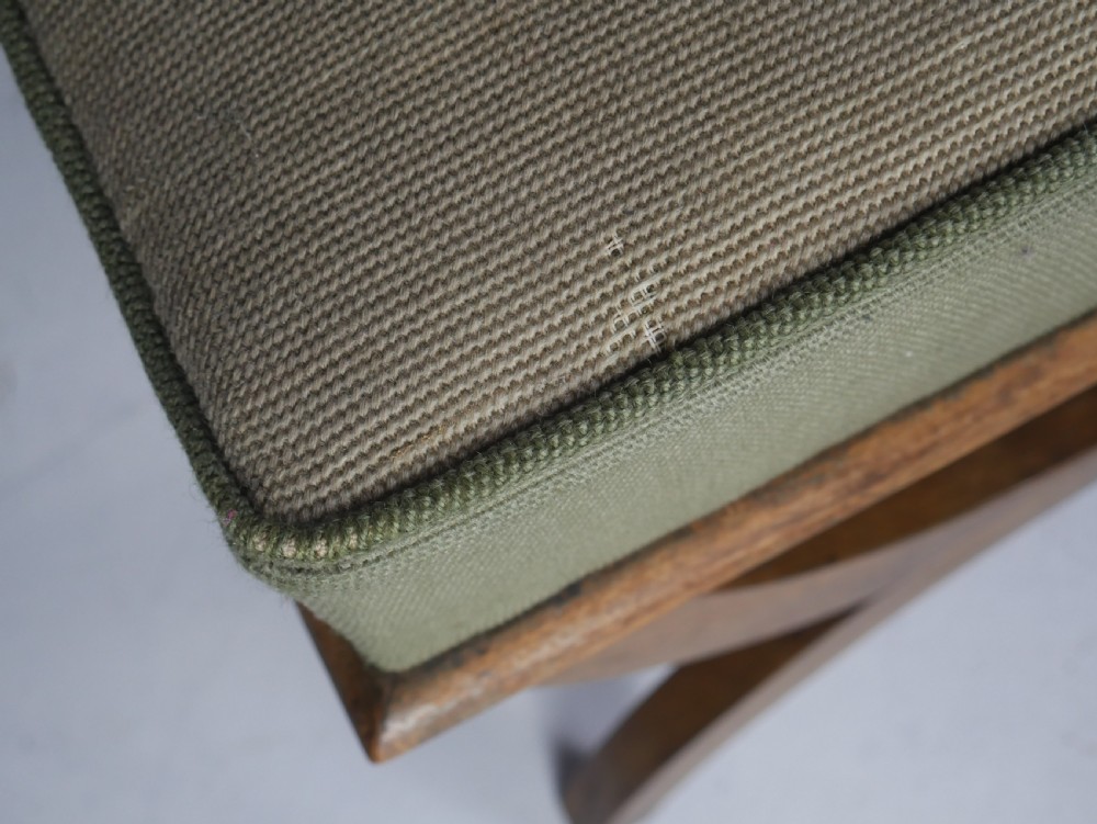 A Regency period rosewood X-frame stool with a turned stretcher bar and a square upholstered top featuring floral needlework set within a green border. View VII