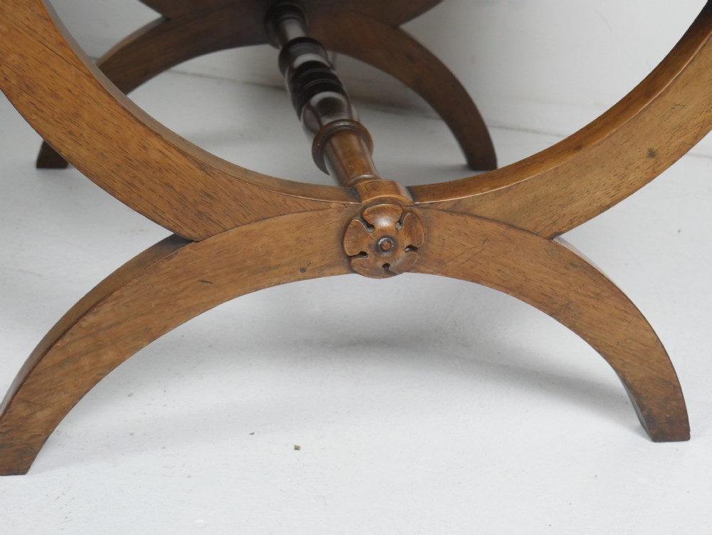 A Regency period rosewood X-frame stool with a turned stretcher bar and a square upholstered top featuring floral needlework set within a green border. View XIV