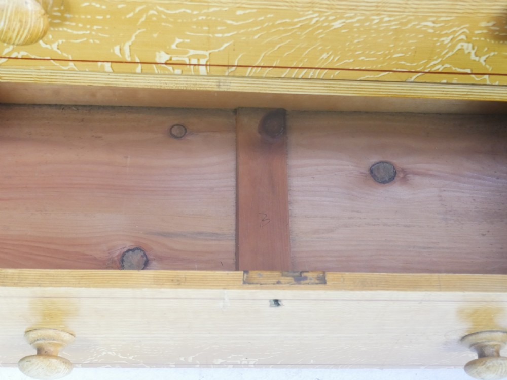 An antique Victorian painted pine chest featuring two short over two long drawers with faux graining, red line borders, wooden knobs, and turned feet. View IX