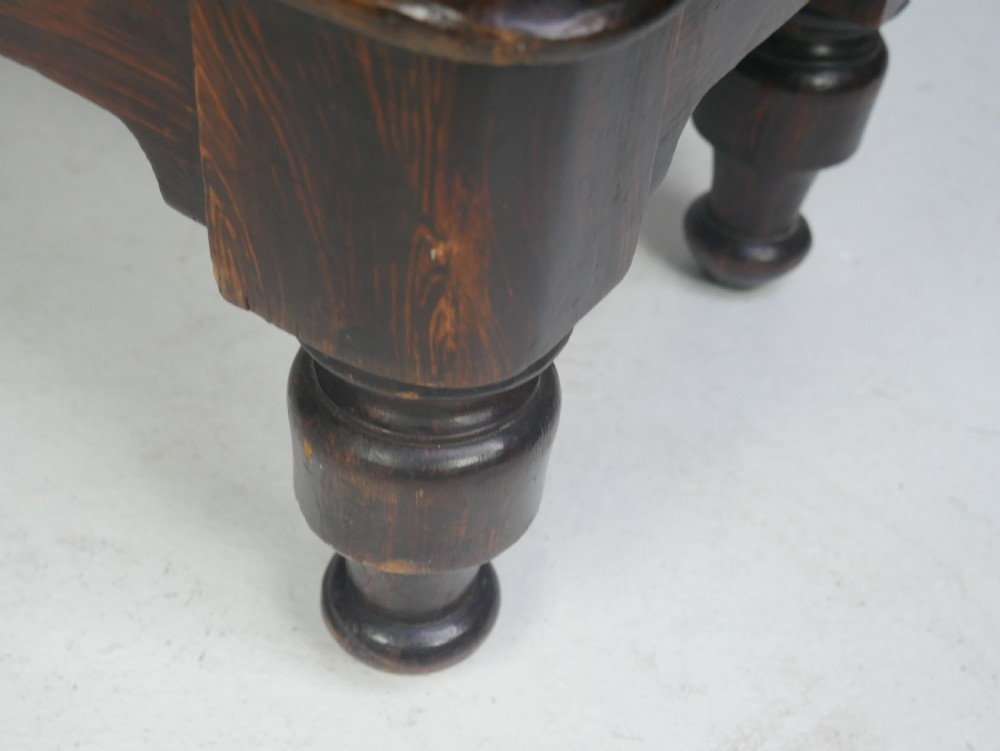 A dark brown 19th-century waterfall bookcase featuring four open stepped shelves, side profile cutouts, and turned legs. View X