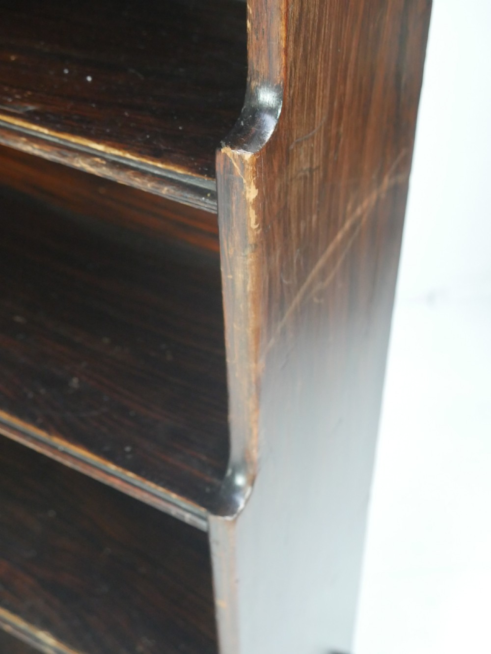 A dark brown 19th-century waterfall bookcase featuring four open stepped shelves, side profile cutouts, and turned legs. View XI