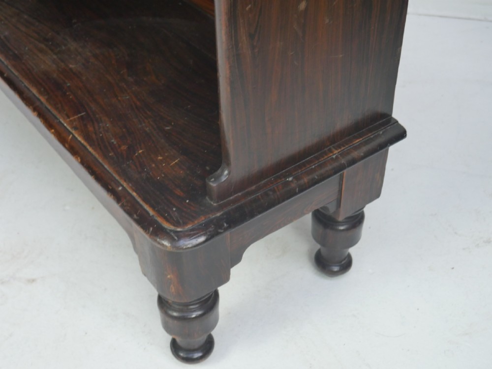 A dark brown 19th-century waterfall bookcase featuring four open stepped shelves, side profile cutouts, and turned legs. View XII