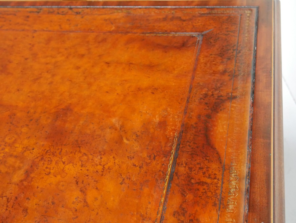 A 19th-century mahogany kneehole partners desk featuring twin pedestals, multiple drawers with brass drop handles, and a flat rectangular writing top. View XV