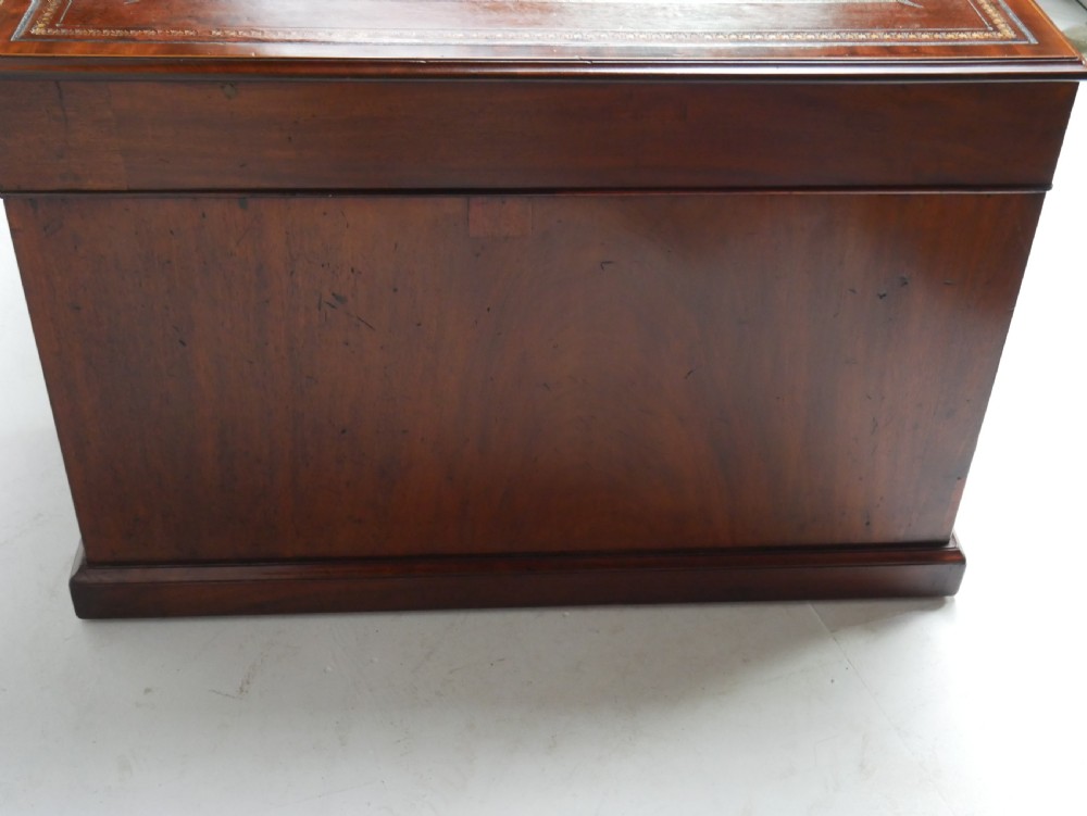 A 19th-century mahogany kneehole partners desk featuring twin pedestals, multiple drawers with brass drop handles, and a flat rectangular writing top. View XVI
