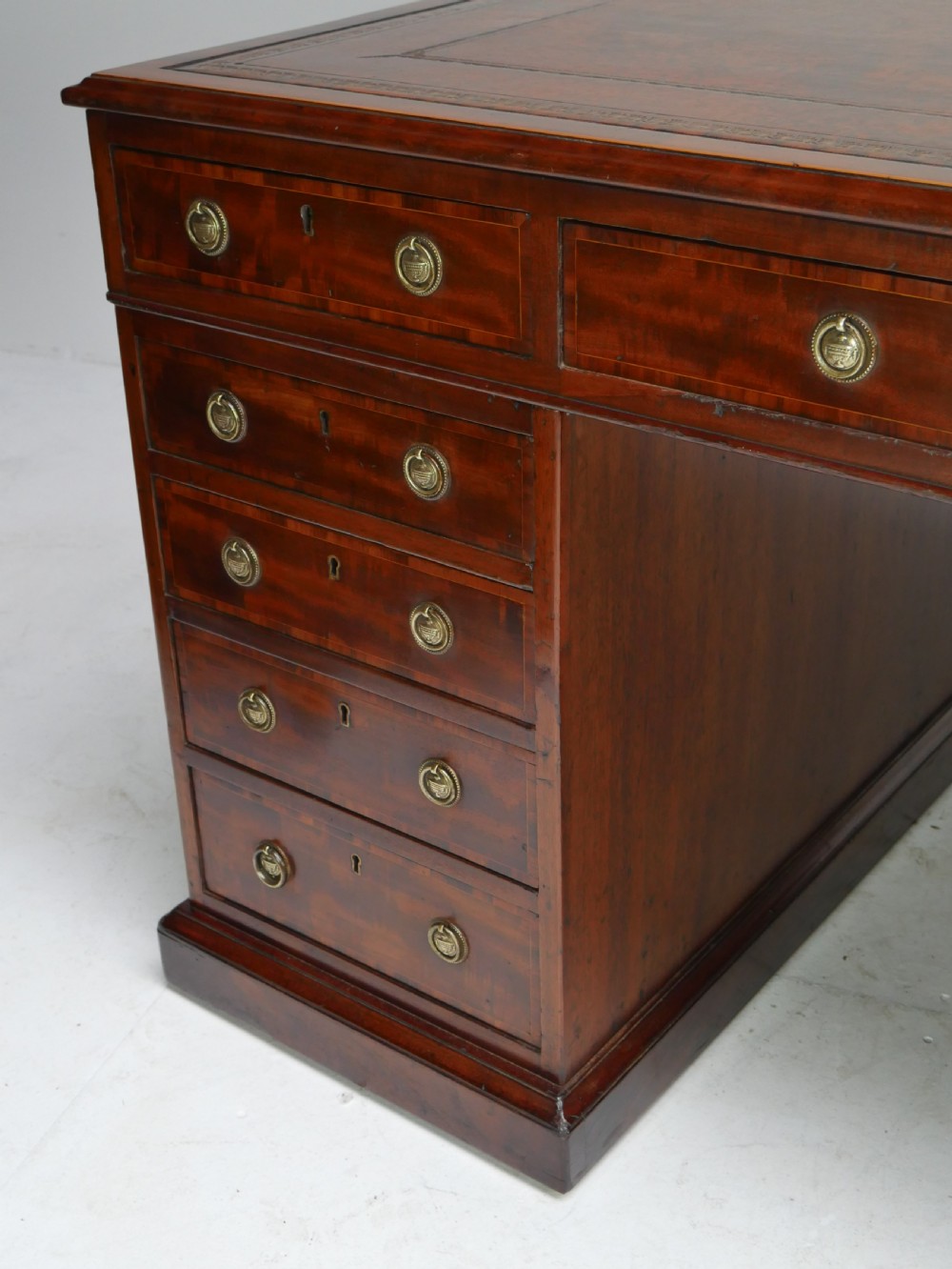 A 19th-century mahogany kneehole partners desk featuring twin pedestals, multiple drawers with brass drop handles, and a flat rectangular writing top. View XIX