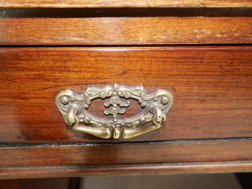 An antique oak partners kneehole desk featuring a leather-inset writing top, brass handles, and twin drawer pedestals on a plinth base. View IX