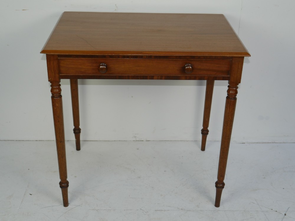 A Regency mahogany writing table featuring a single drawer with two turned wooden knobs, supported by four slim turned tapered legs. View VIII
