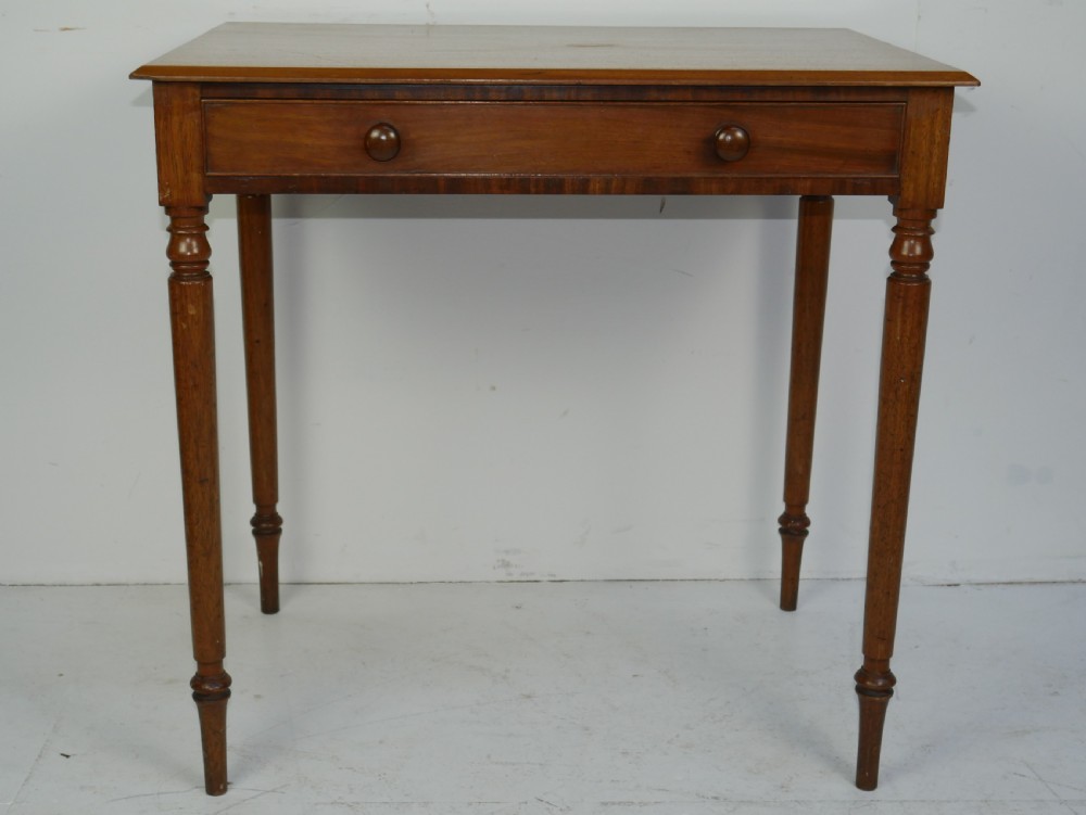 A Regency mahogany writing table featuring a single drawer with two turned wooden knobs, supported by four slim turned tapered legs. View IX