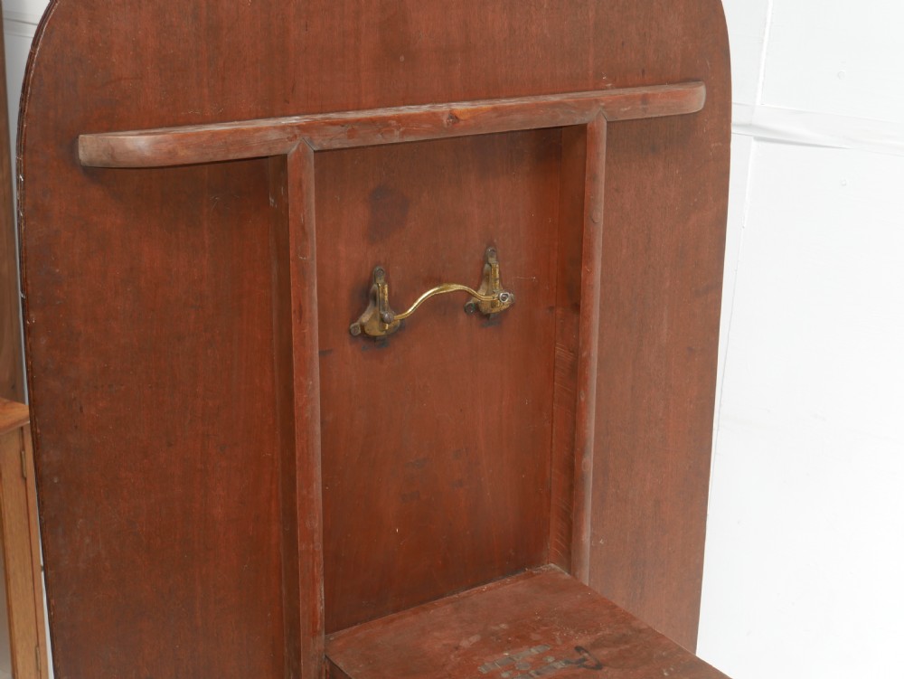 A Georgian mahogany centre table featuring a rounded rectangular top supported by a central pedestal with four reeded splayed legs and brass castors. View VII