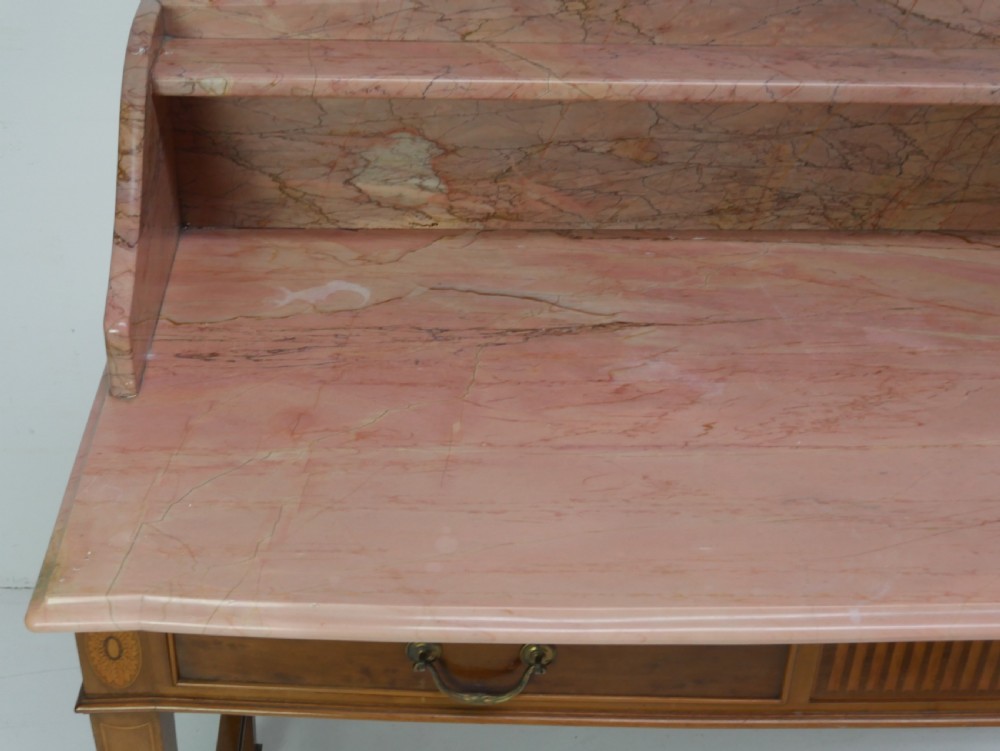 A mahogany writing table featuring two inlaid drawers, square tapered legs, and a pink marble top with a raised gallery back. View II