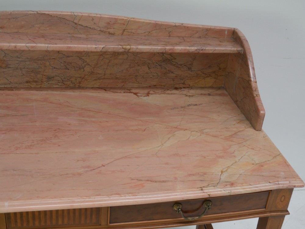 A mahogany writing table featuring two inlaid drawers, square tapered legs, and a pink marble top with a raised gallery back. View VIII