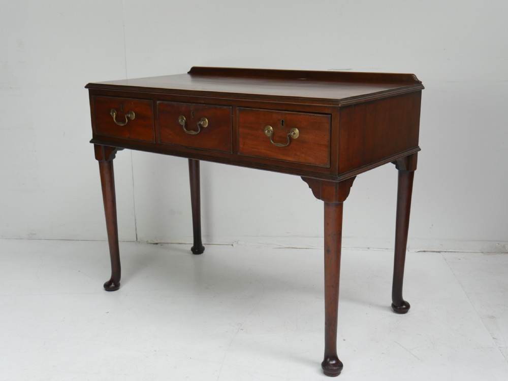 A 19th-century mahogany console table featuring three drawers with brass swan-neck handles and slender cabriole legs ending in pad feet. View III