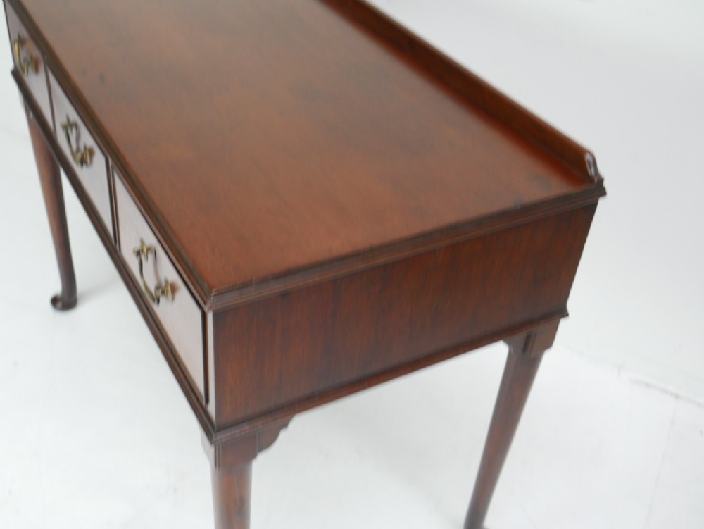 A 19th-century mahogany console table featuring three drawers with brass swan-neck handles and slender cabriole legs ending in pad feet. View VII