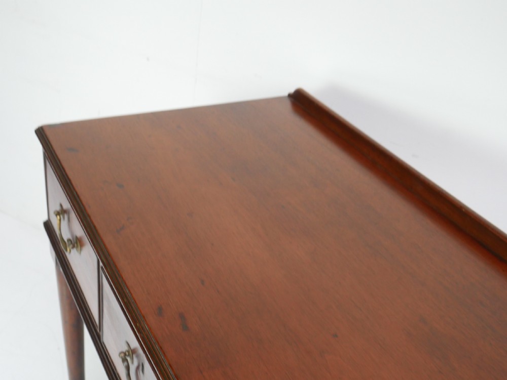 A 19th-century mahogany console table featuring three drawers with brass swan-neck handles and slender cabriole legs ending in pad feet. View VIII