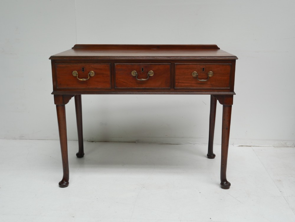 A 19th-century mahogany console table featuring three drawers with brass swan-neck handles and slender cabriole legs ending in pad feet. View IX