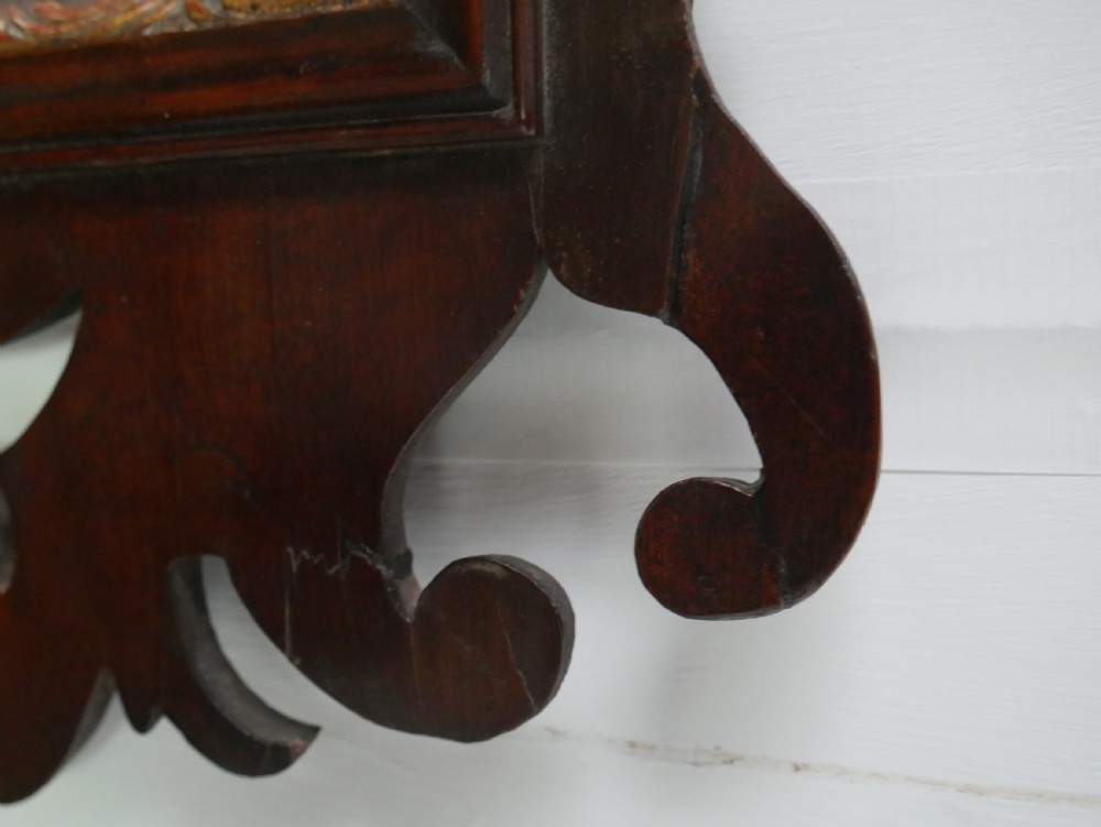 A rectangular Georgian mahogany wall mirror featuring a scroll-cut fretwork frame ornamented with giltwood leaves and cresting. View IV
