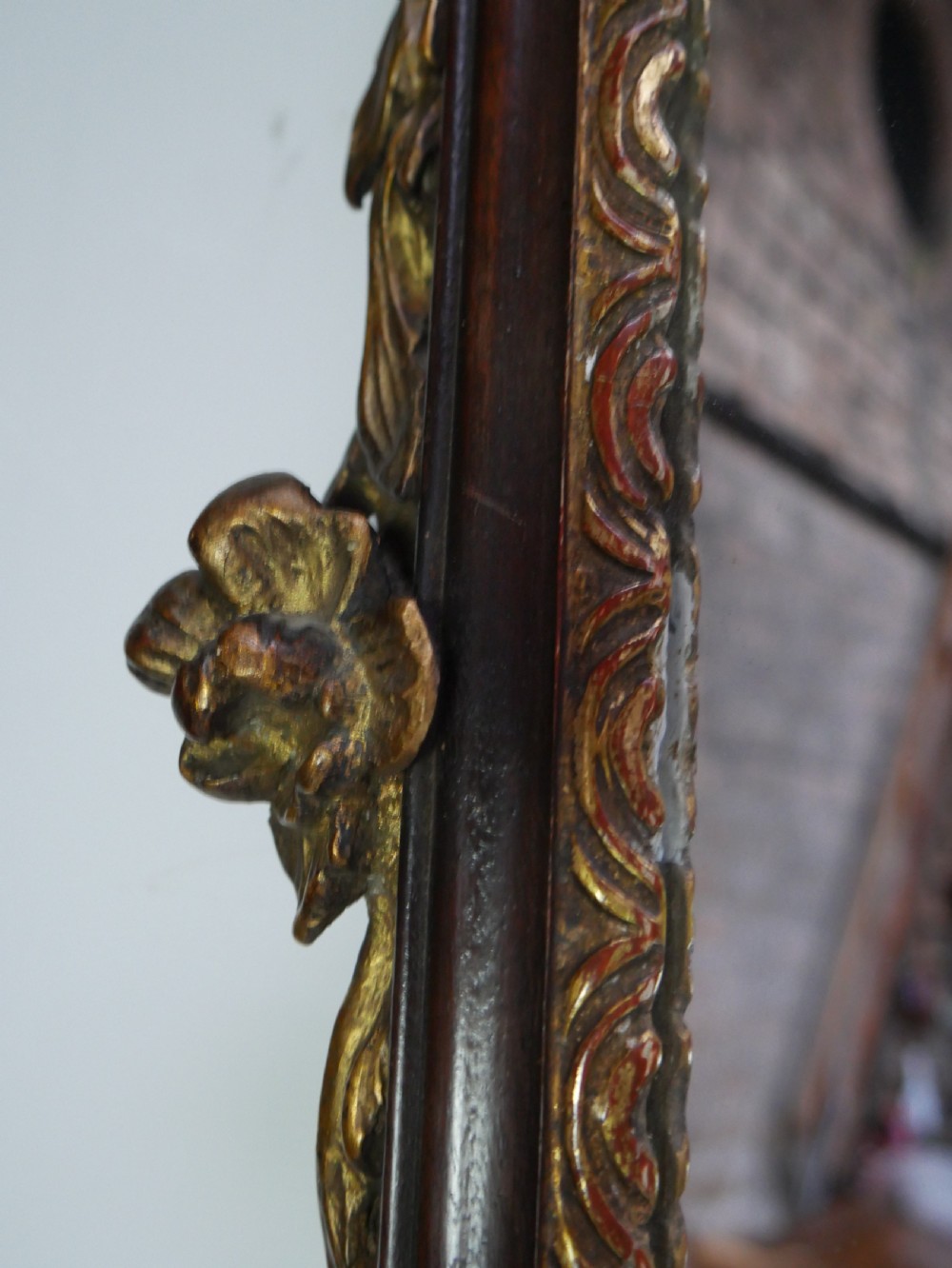 A rectangular Georgian mahogany wall mirror featuring a scroll-cut fretwork frame ornamented with giltwood leaves and cresting. View V