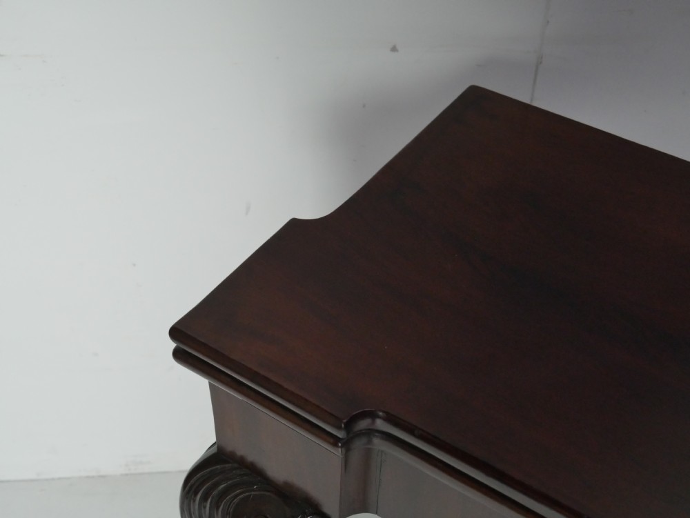 A Georgian mahogany fold-over games table featuring carved cabriole front legs with pad feet and a rectangular top with turret corners. View II