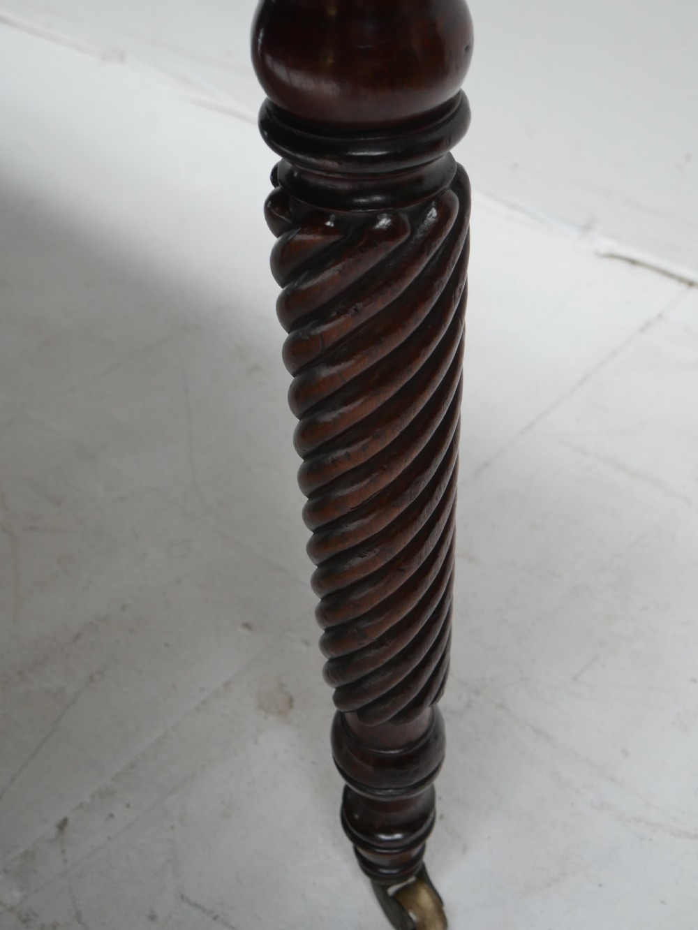 A large antique mahogany extending dining table featuring spiral-turned legs and fitted brass castors. View VI