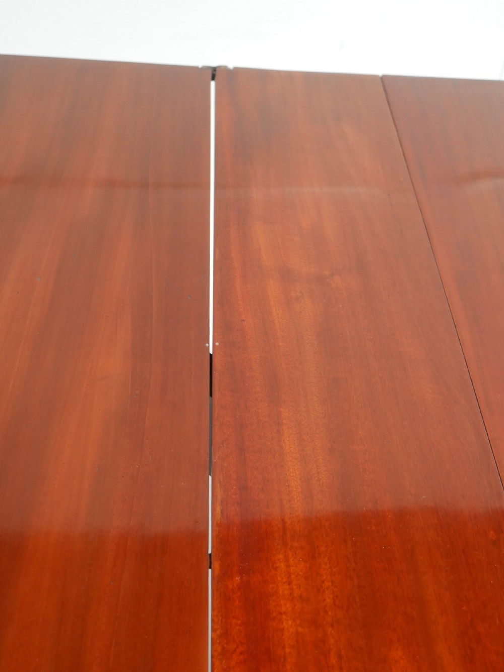 A large antique mahogany extending dining table featuring spiral-turned legs and fitted brass castors. View X