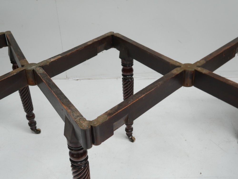 A large antique mahogany extending dining table featuring spiral-turned legs and fitted brass castors. View XIII