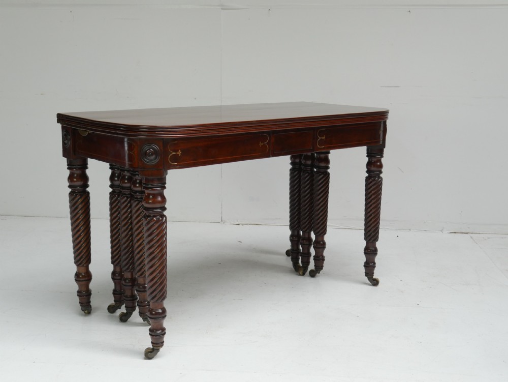 A large antique mahogany extending dining table featuring spiral-turned legs and fitted brass castors. View XVI