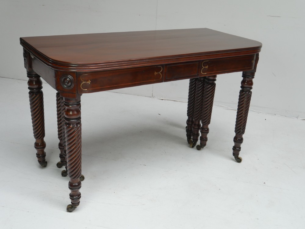 A large antique mahogany extending dining table featuring spiral-turned legs and fitted brass castors. View XVII