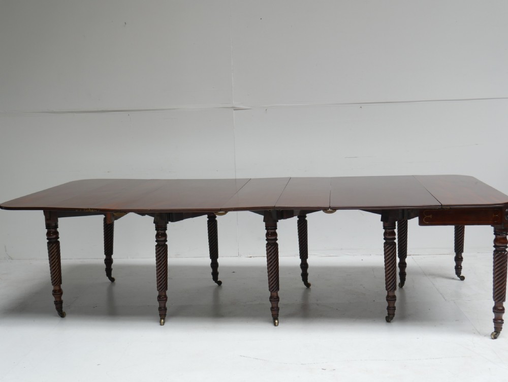 A large antique mahogany extending dining table featuring spiral-turned legs and fitted brass castors. View XVIII