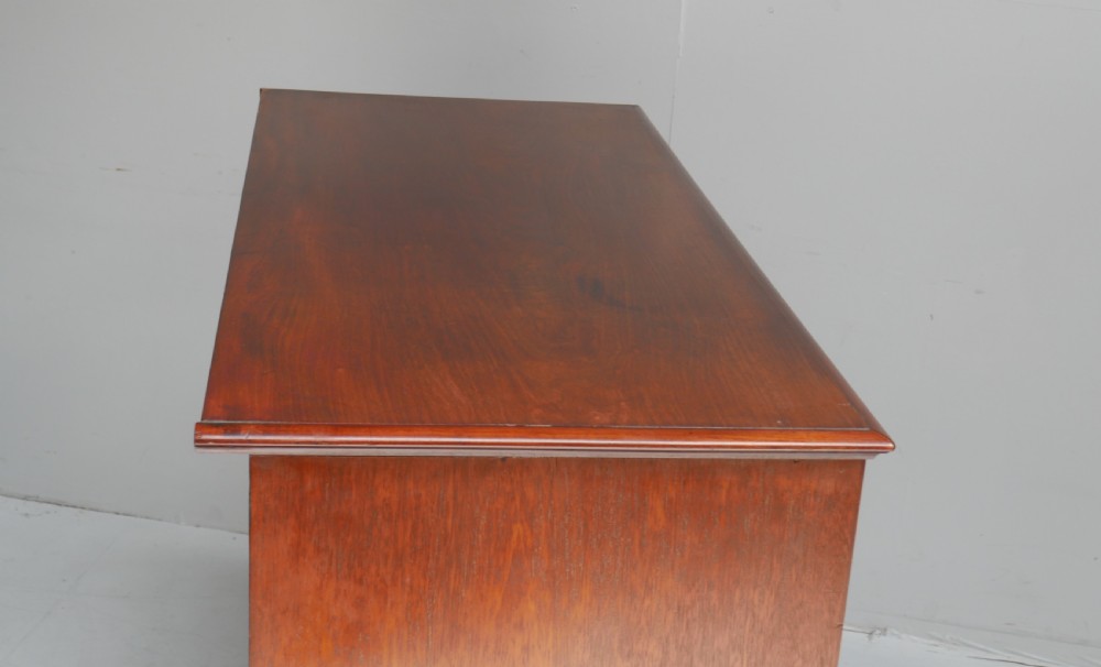 A classic Regency mahogany chest featuring four horizontal drawers with flame mahogany grain, turned wooden knobs, brass keyhole escutcheons, and turned feet. View VIII