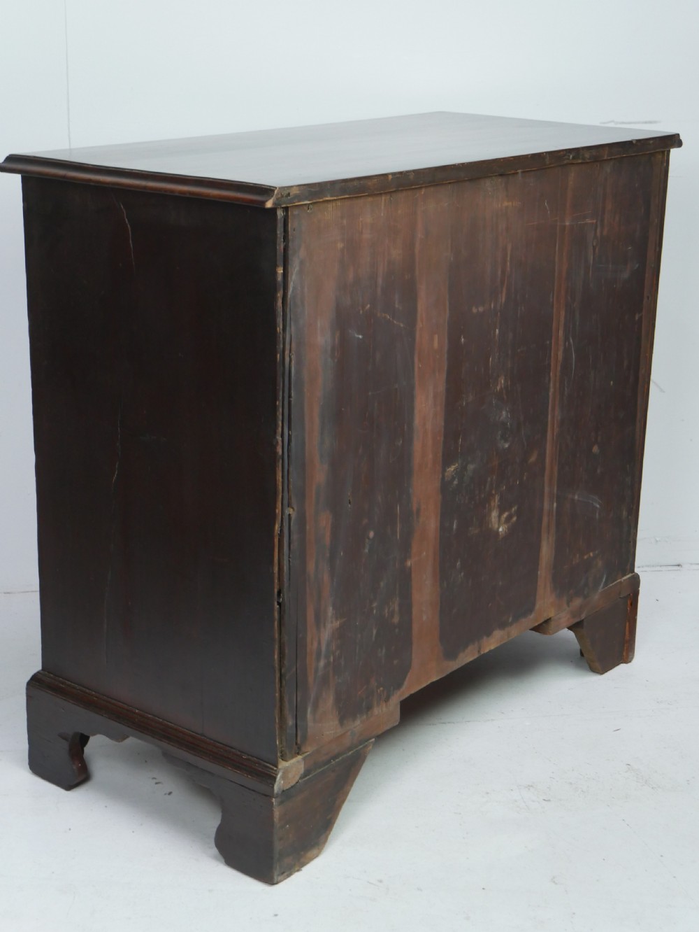 A Georgian mahogany chest of drawers featuring four graduated drawers with brass swan-neck handles and bracket feet. View VII