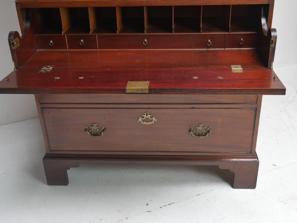 An eighteenth-century Georgian dark mahogany secretaire tallboy featuring two stacked chest sections, brass handles, and bracket feet. View III