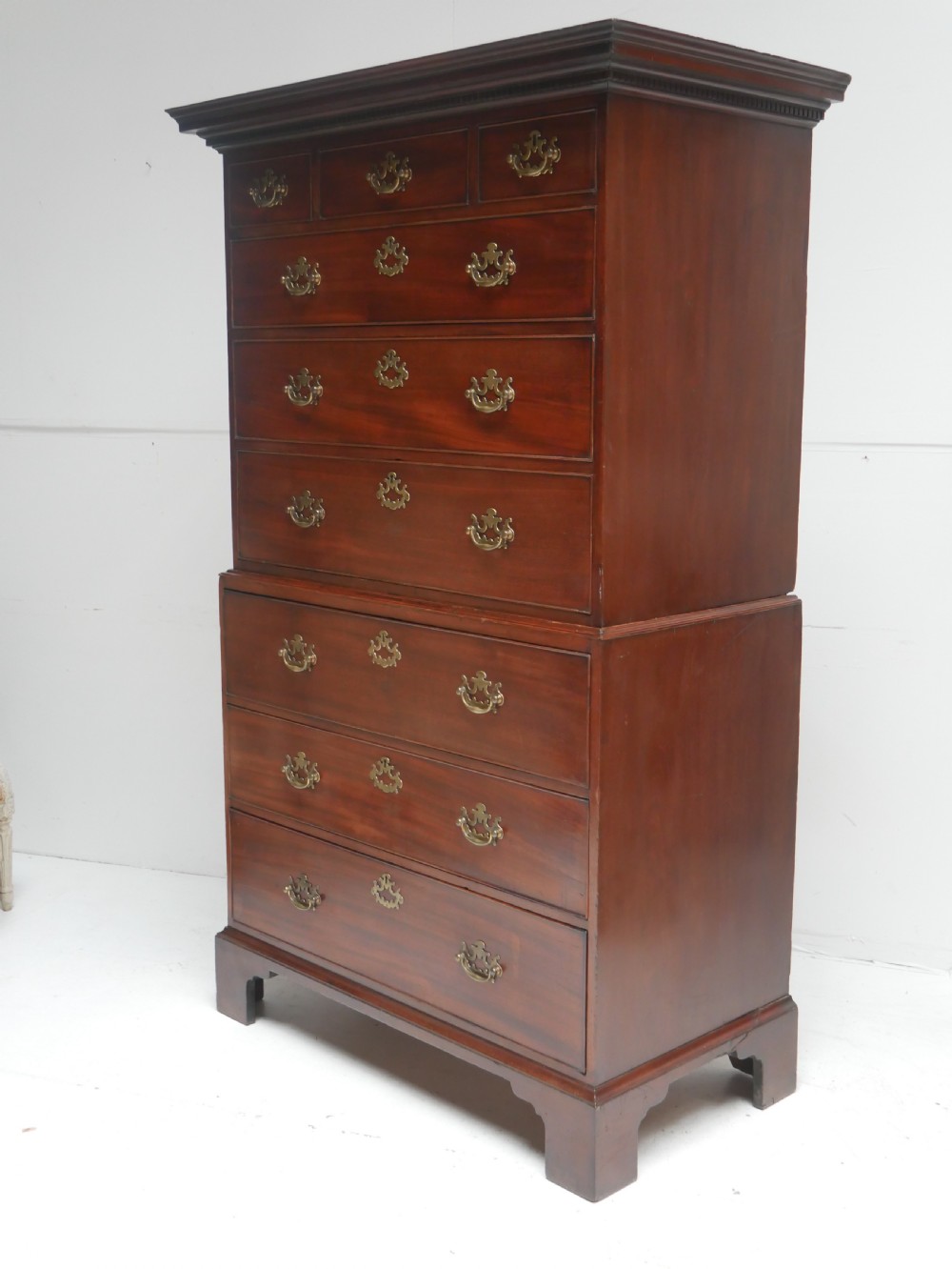 An eighteenth-century Georgian dark mahogany secretaire tallboy featuring two stacked chest sections, brass handles, and bracket feet. View V