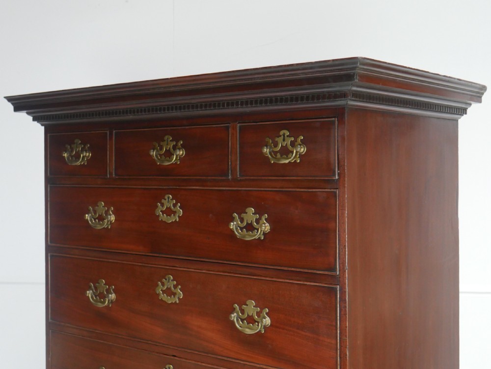 An eighteenth-century Georgian dark mahogany secretaire tallboy featuring two stacked chest sections, brass handles, and bracket feet. View VI
