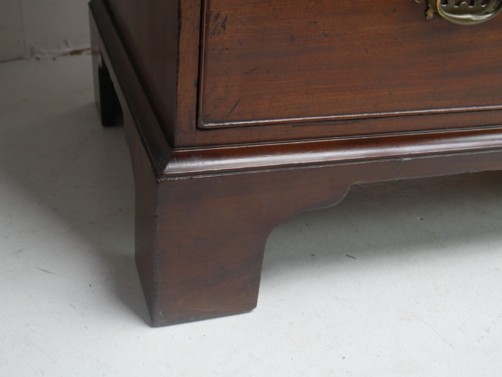 An eighteenth-century Georgian dark mahogany secretaire tallboy featuring two stacked chest sections, brass handles, and bracket feet. View VII