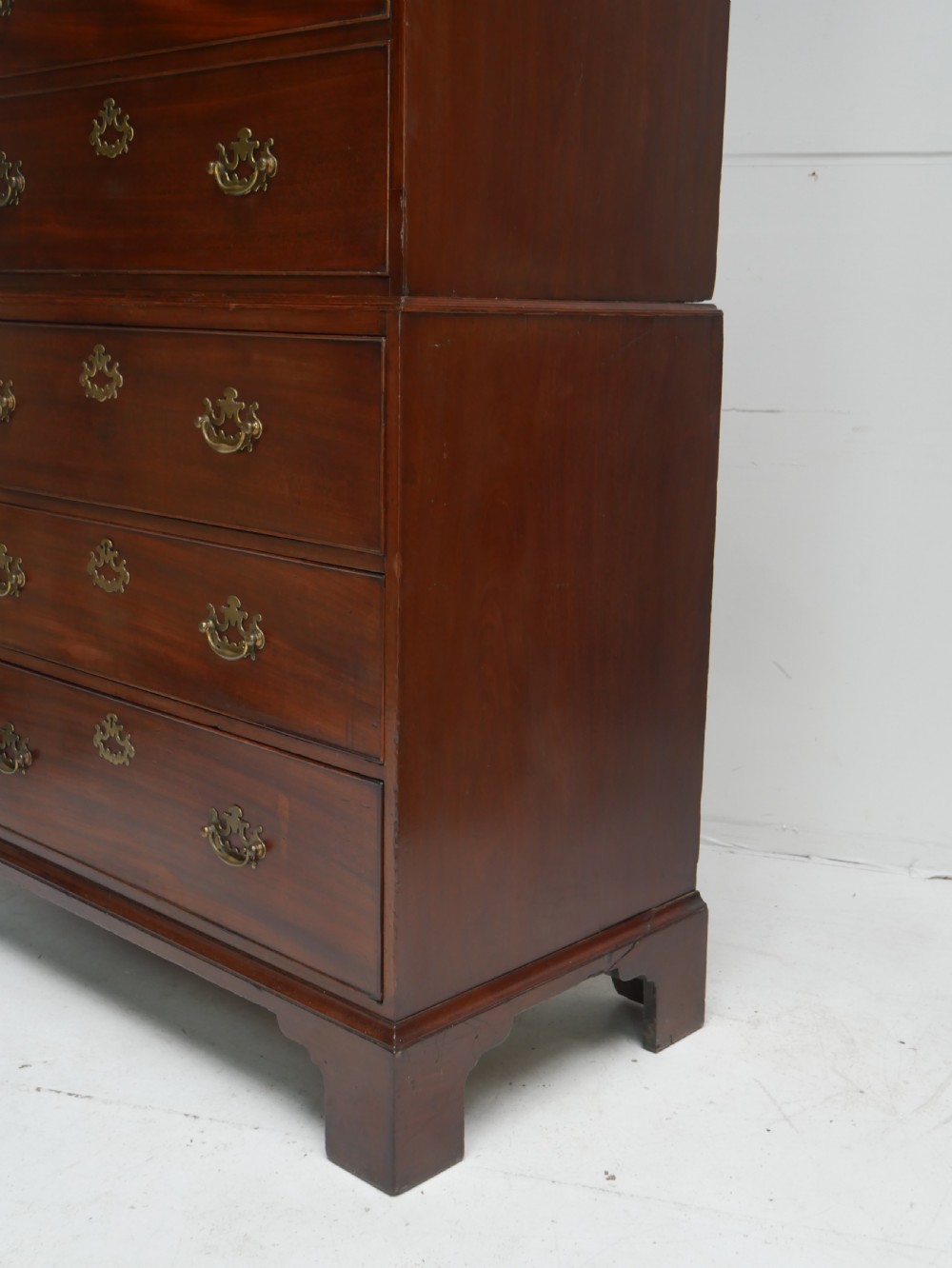 An eighteenth-century Georgian dark mahogany secretaire tallboy featuring two stacked chest sections, brass handles, and bracket feet. View XI