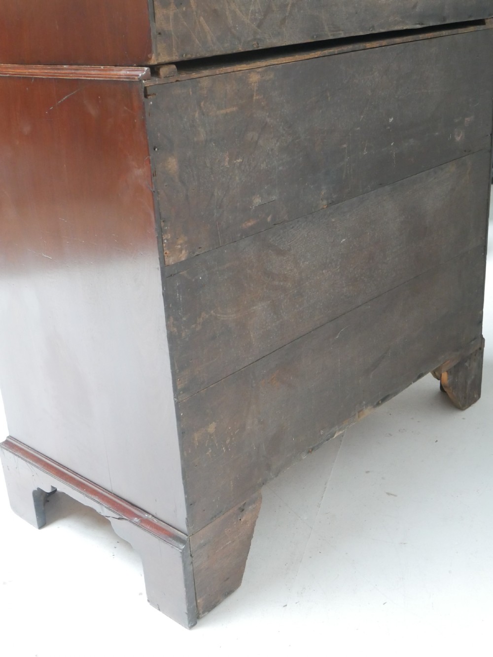 An eighteenth-century Georgian dark mahogany secretaire tallboy featuring two stacked chest sections, brass handles, and bracket feet. View XIII