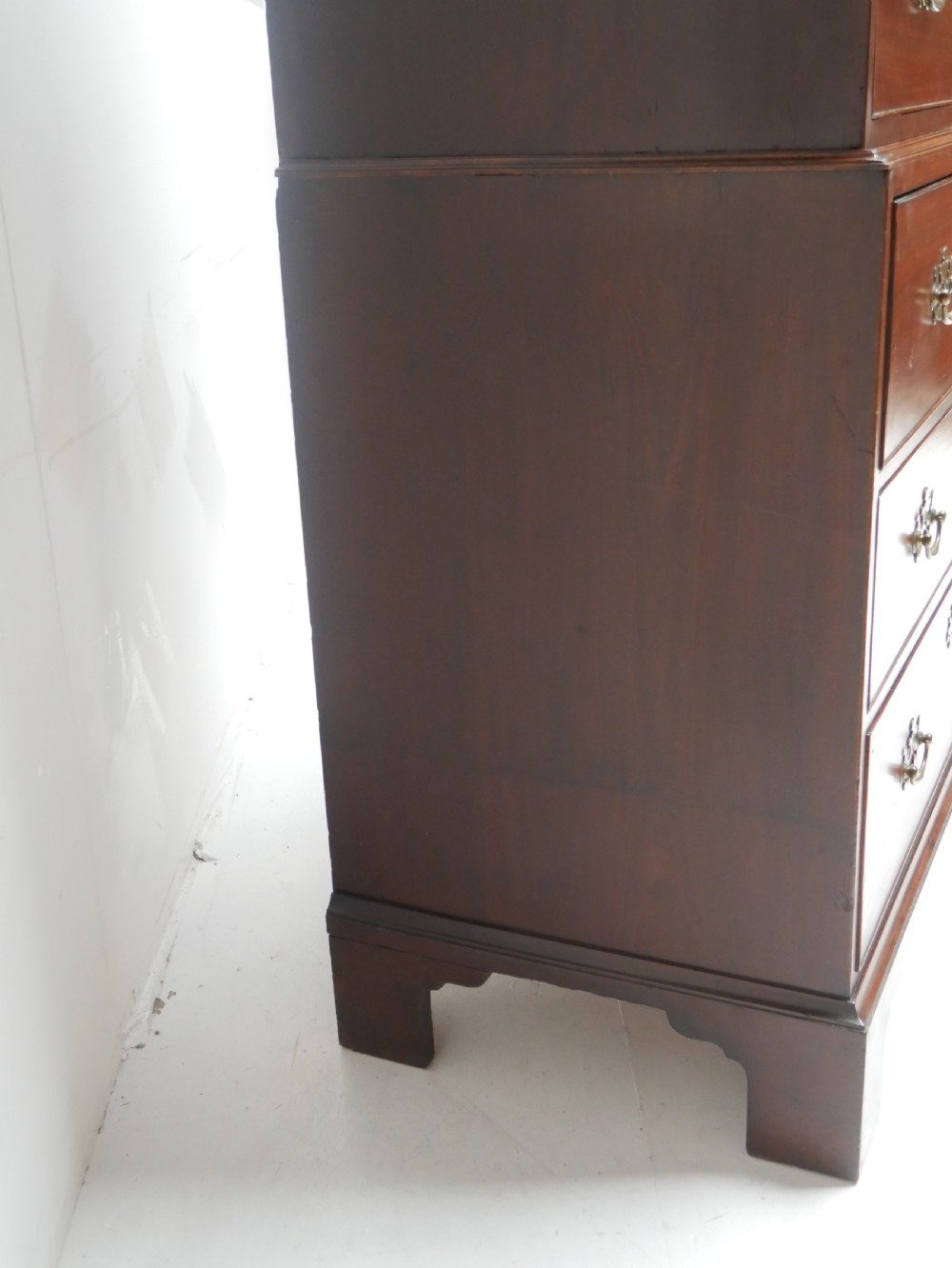An eighteenth-century Georgian dark mahogany secretaire tallboy featuring two stacked chest sections, brass handles, and bracket feet. View XIV