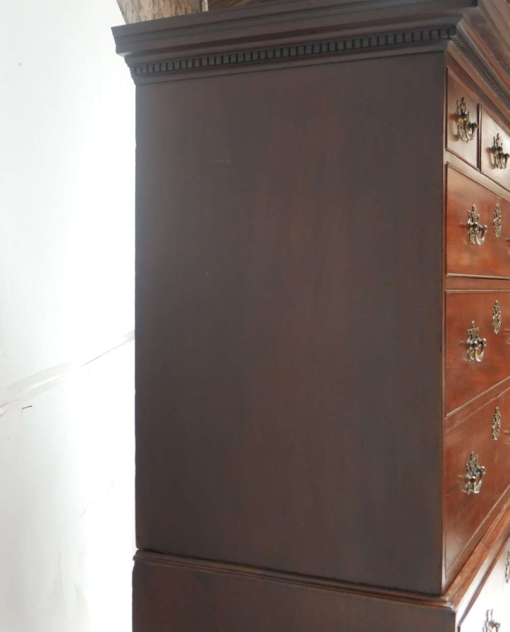 An eighteenth-century Georgian dark mahogany secretaire tallboy featuring two stacked chest sections, brass handles, and bracket feet. View XV