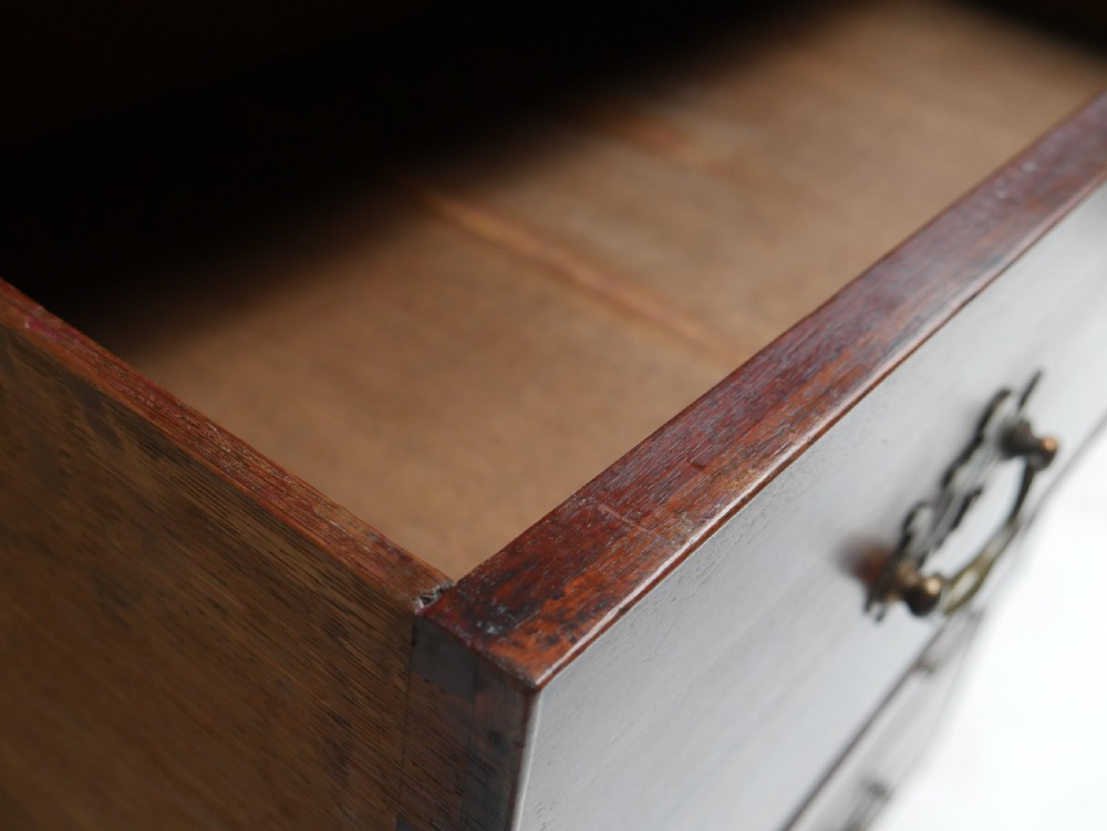 An eighteenth-century Georgian dark mahogany secretaire tallboy featuring two stacked chest sections, brass handles, and bracket feet. View XVII