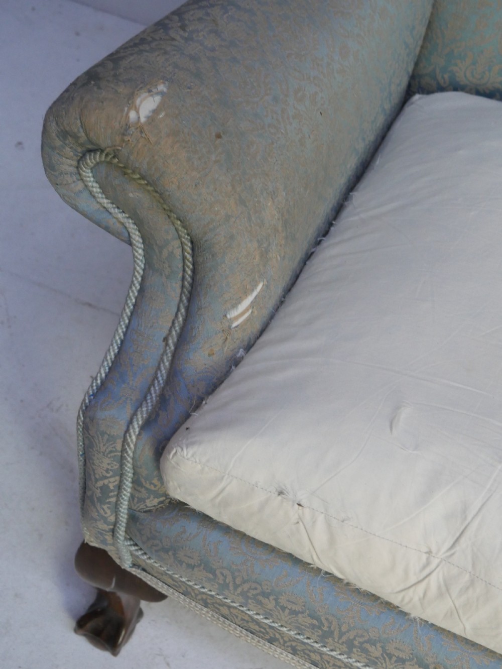 A high-backed wing armchair upholstered in patterned blue damask fabric with a deep buttoned backrest and carved wood cabriole front legs. View III
