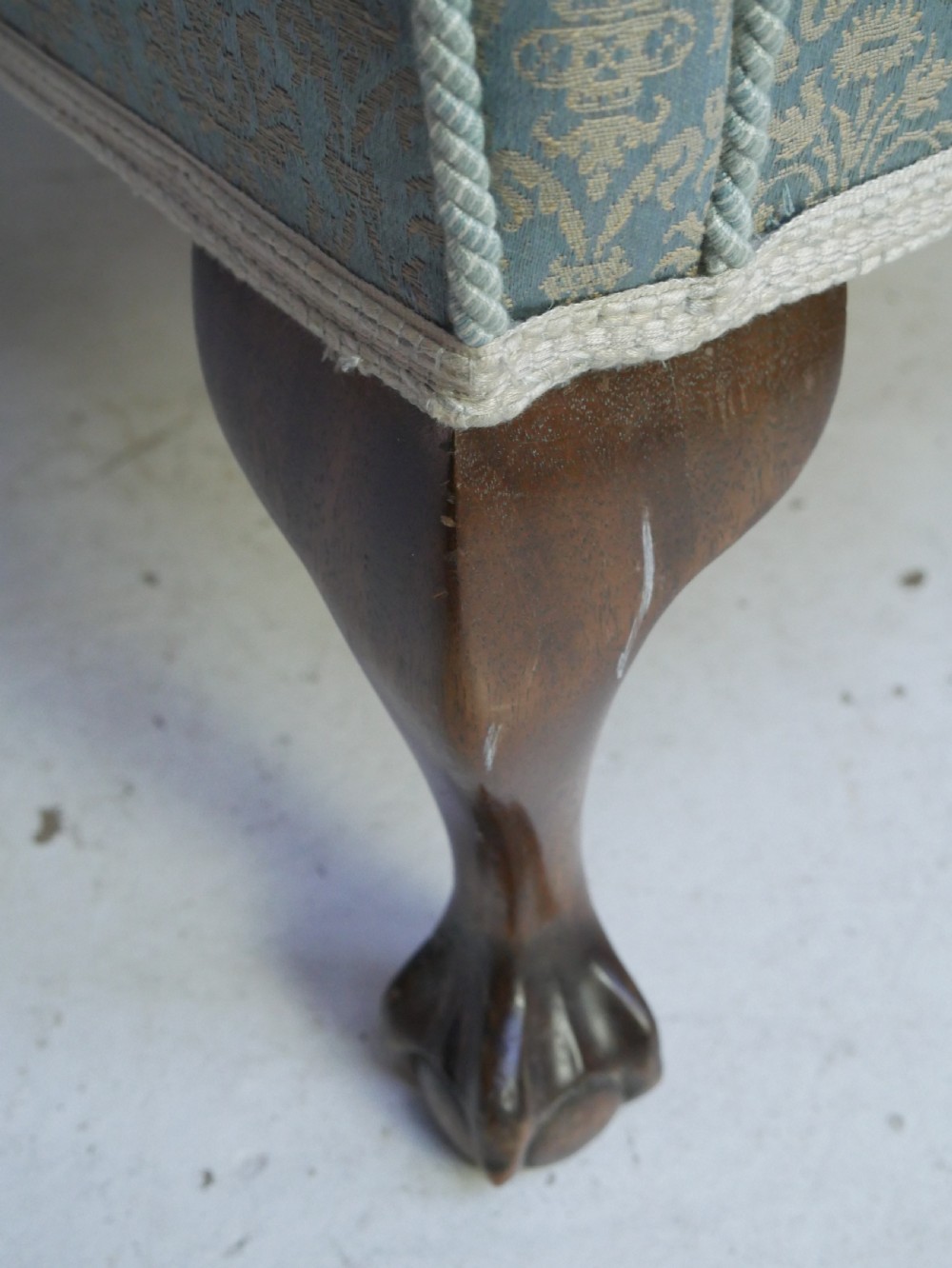 A high-backed wing armchair upholstered in patterned blue damask fabric with a deep buttoned backrest and carved wood cabriole front legs. View XI