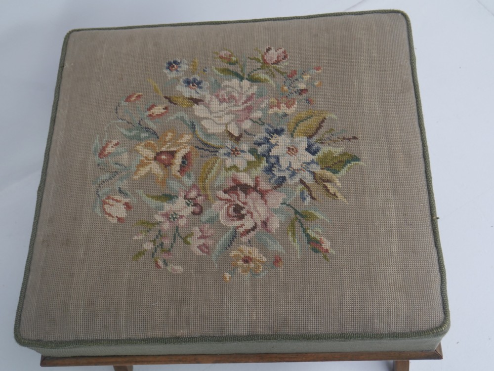 A Regency period rosewood X-frame stool with a turned stretcher bar and a square upholstered top featuring floral needlework set within a green border. View V