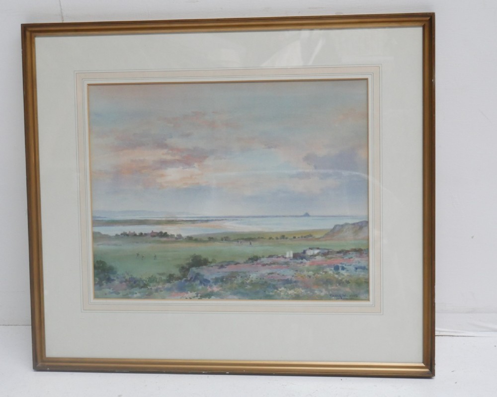 A framed mid-20th-century watercolour painting depicting an expansive coastal landscape under a soft sky, contained within a gilt wooden frame.