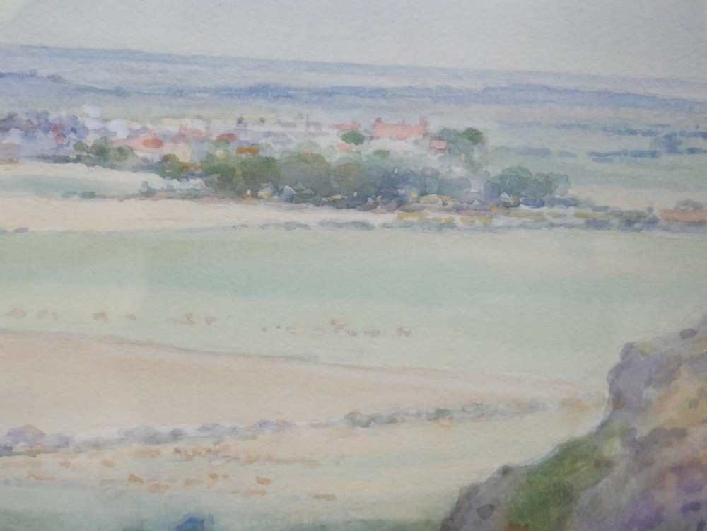 A framed watercolour landscape painting by Frank Wood depicting Bamburgh Castle on the Northumberland coast under a pale sky. View VI