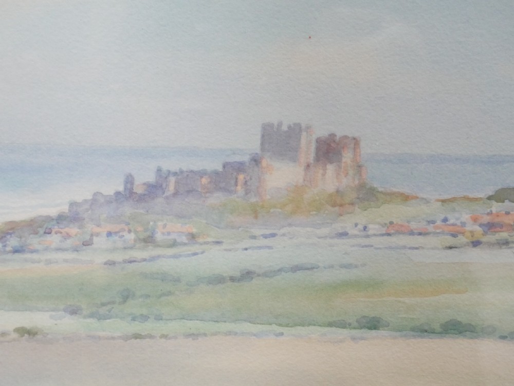 A framed watercolour landscape painting by Frank Wood depicting Bamburgh Castle on the Northumberland coast under a pale sky. View VII