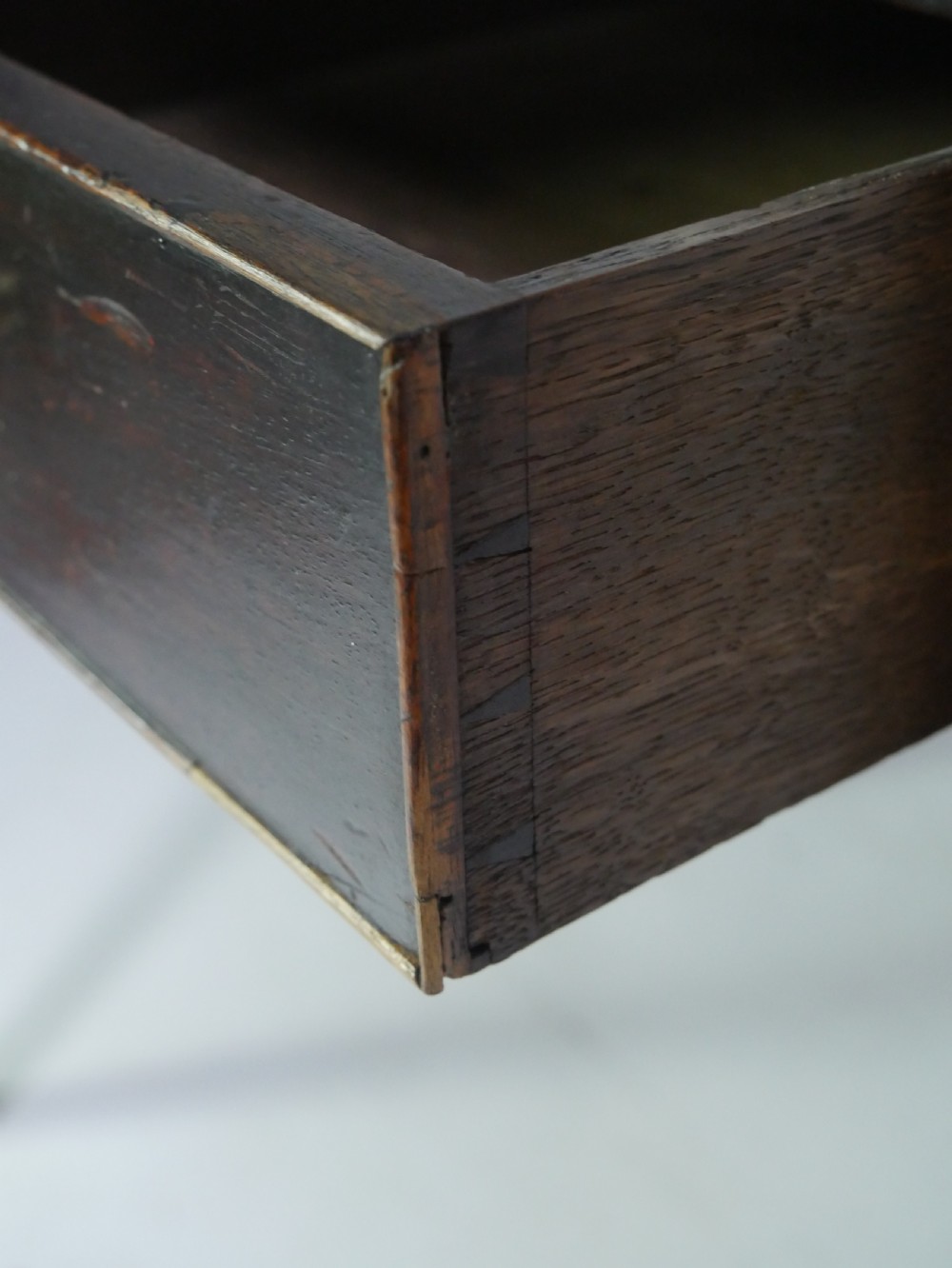 A dark mahogany Georgian side table featuring two front drawers with brass swan-neck handles and square tapered legs. View VIII