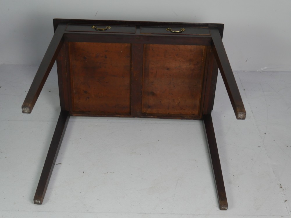 A dark mahogany Georgian side table featuring two front drawers with brass swan-neck handles and square tapered legs. View IX