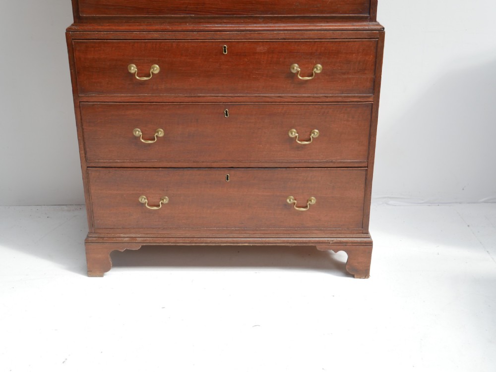 A tall Georgian oak chest on chest featuring brass swan-neck handles, keyhole escutcheons, and bracket feet. View II