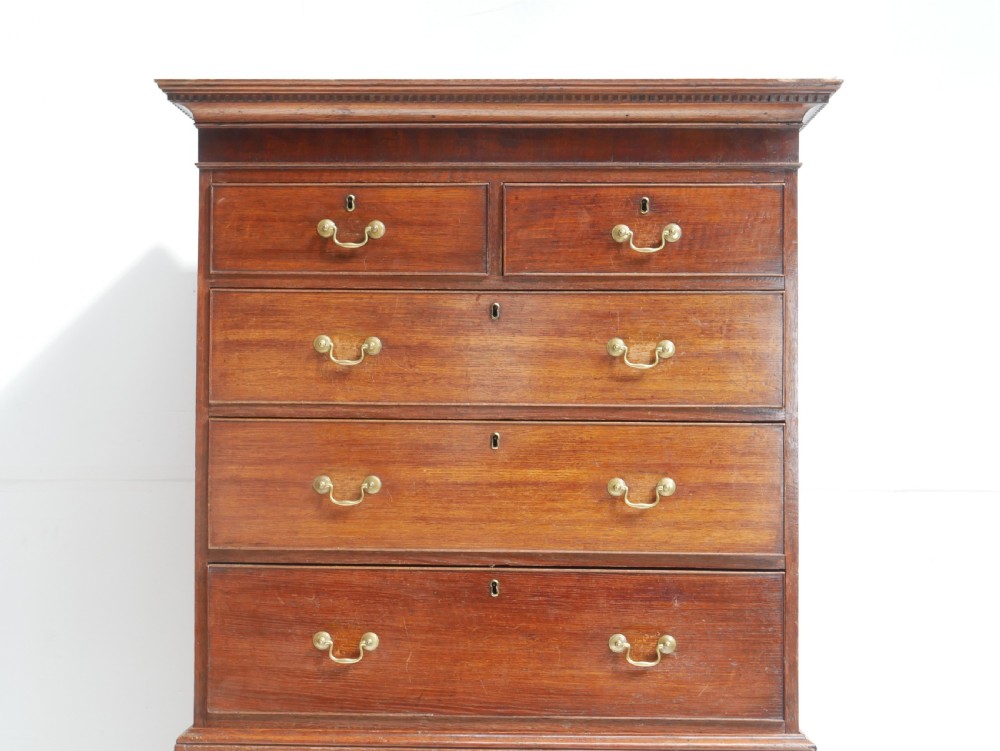 A tall Georgian oak chest on chest featuring brass swan-neck handles, keyhole escutcheons, and bracket feet. View III