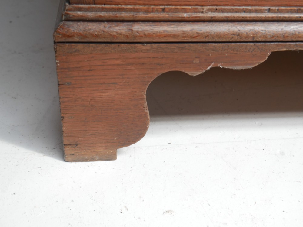 A tall Georgian oak chest on chest featuring brass swan-neck handles, keyhole escutcheons, and bracket feet. View IX